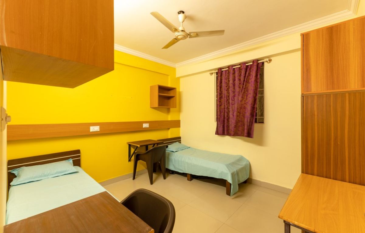 Premium student room with attached bathroom at Pelagia Palace PG near Christ University