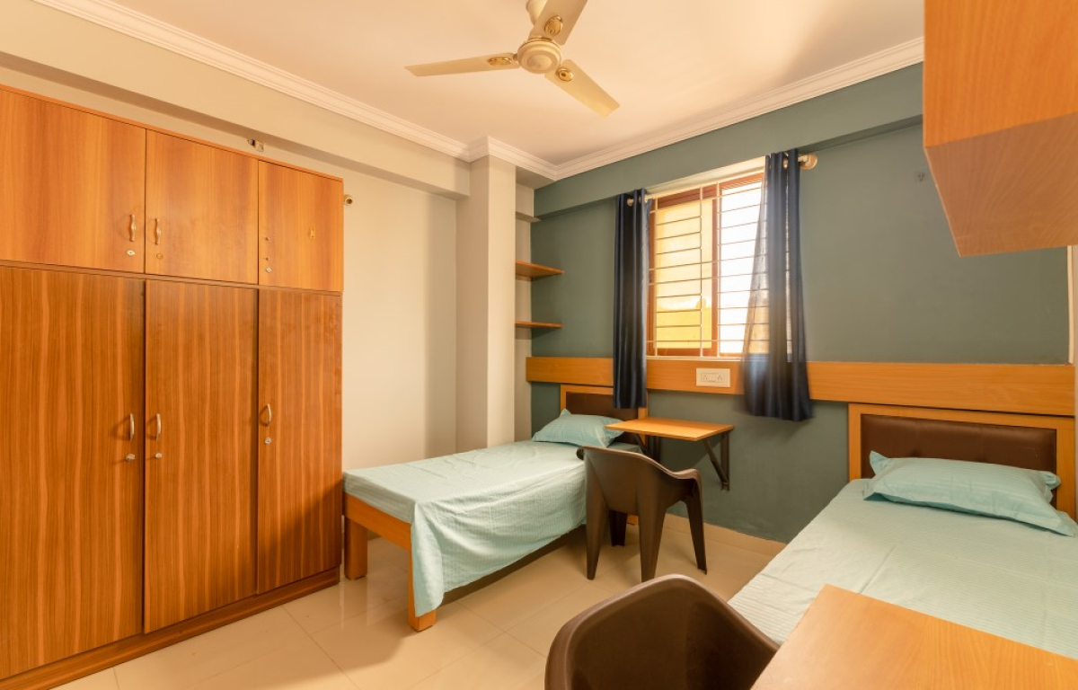 Spacious wardrobe and personal study desk in Pelagia Palace PG student room