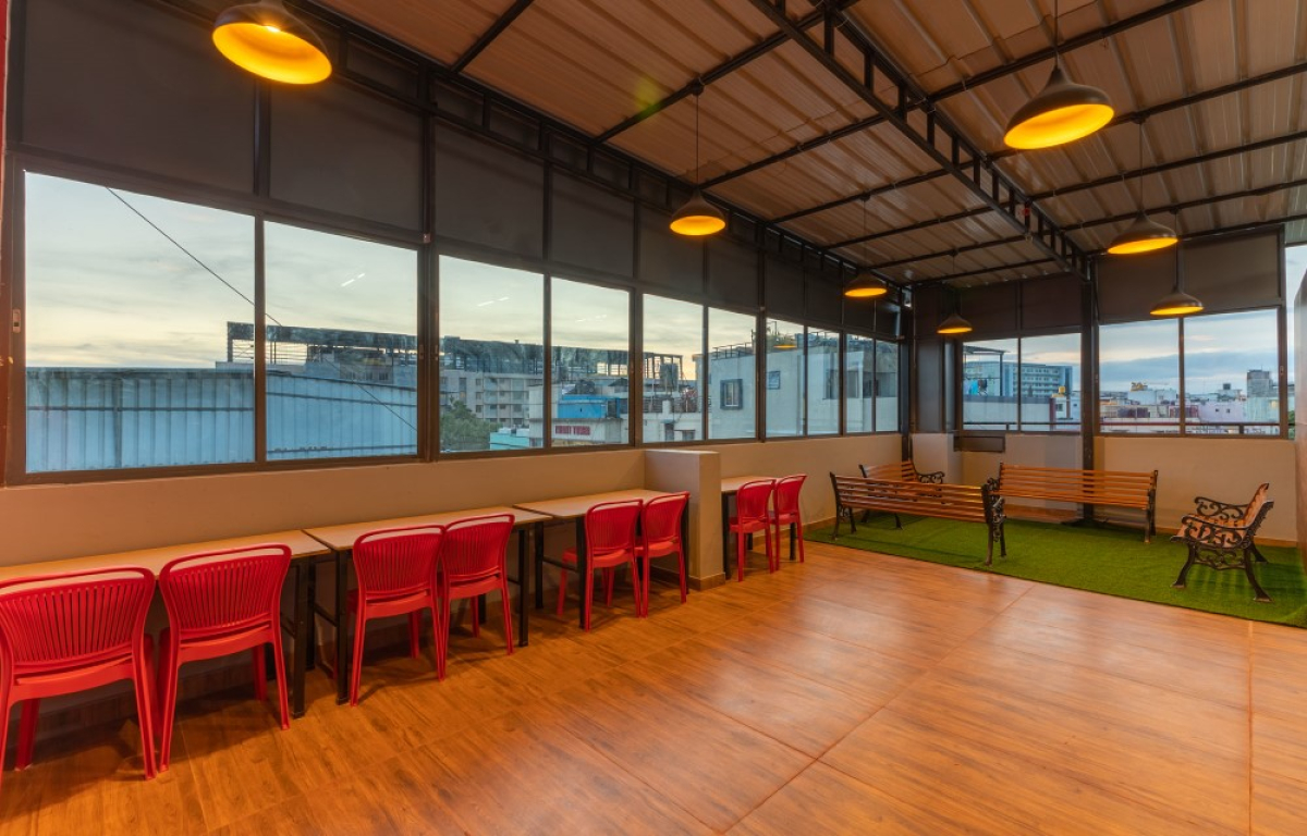 Common lounge with TV and comfortable seating at Pelagia Palace PG Bangalore